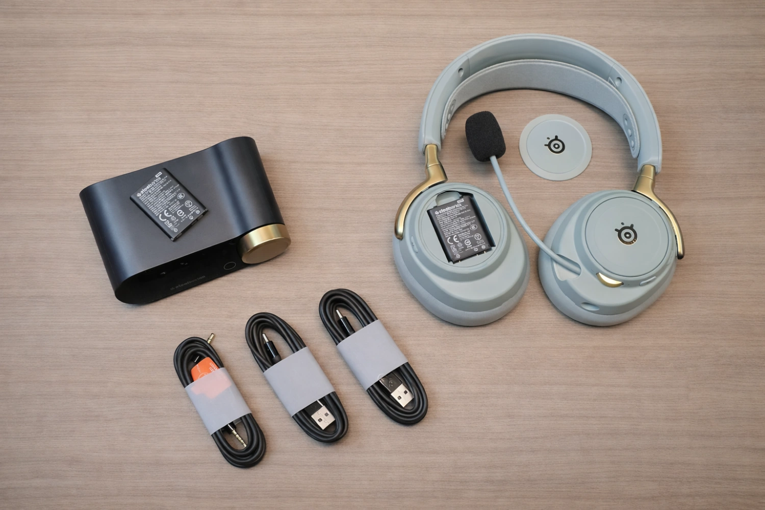 A complete ecosystem: headset, wireless base station, dual batteries, and neatly bundled cables ready for plug-and-play performance.